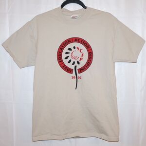 2002 Sunflower County Freedom Project Beige Shirt. Adult Medium. Good Condition.